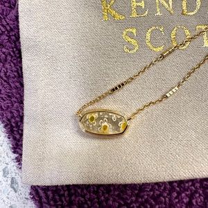 Kendra Scott gold necklace with flower imprint pendant
